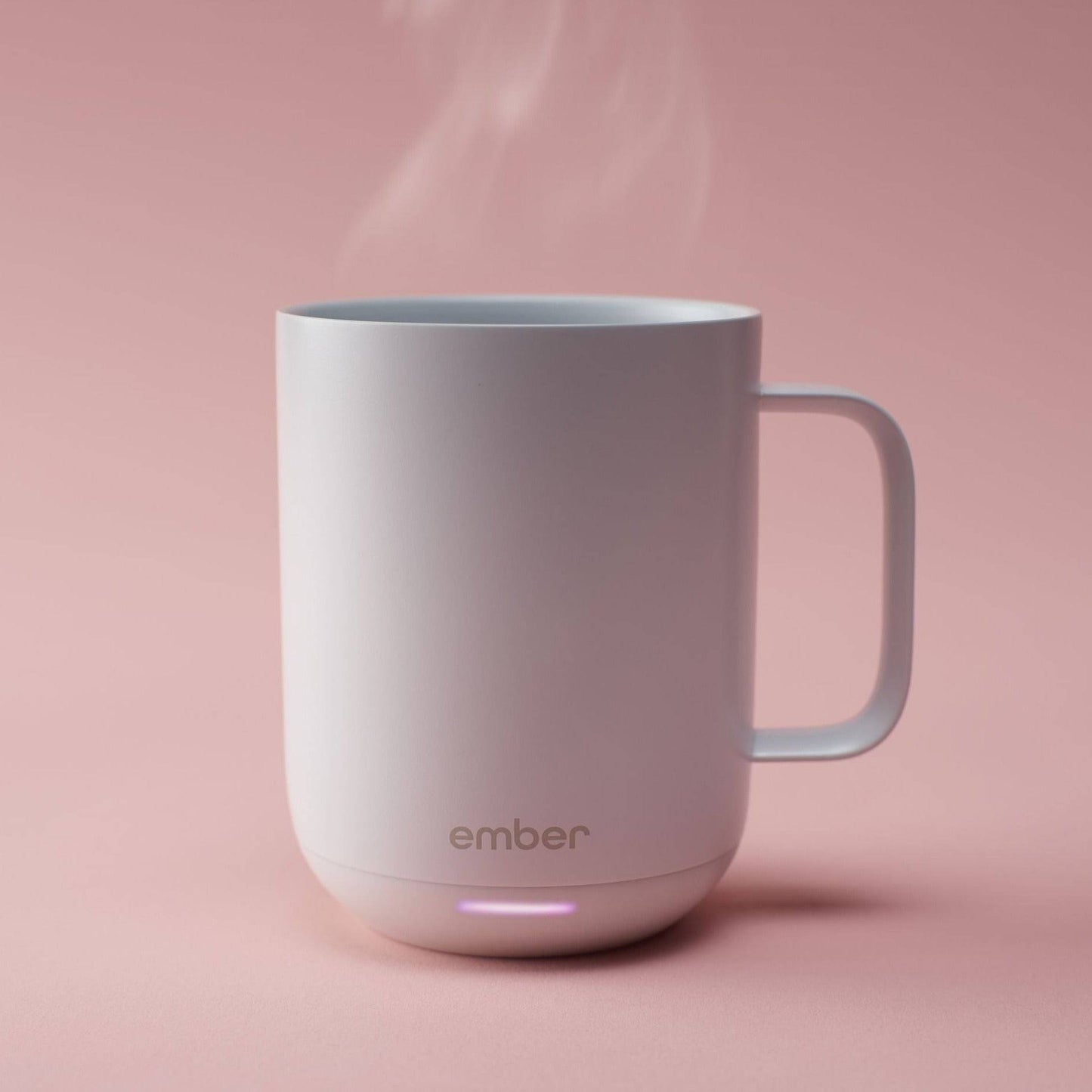 White Ember Mug with steaming coffee on a pink background
