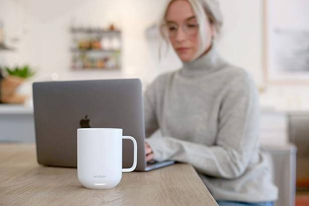 Ember Mug in White, woman working on laptop.