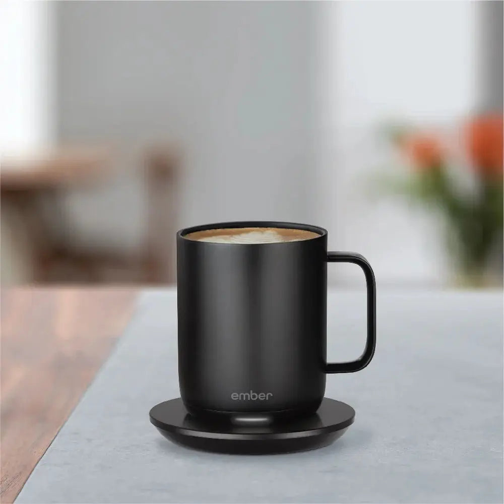 Ember Mug in Black on a table